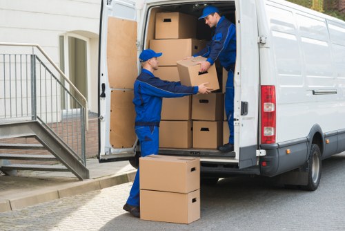 Packed moving boxes and furniture ready for transport in a Tooting home move