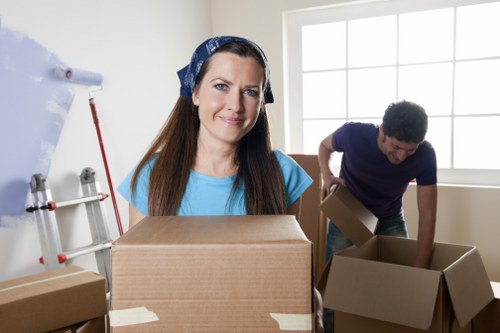 Packed boxes and furniture prepared for house removals in a Tooting property